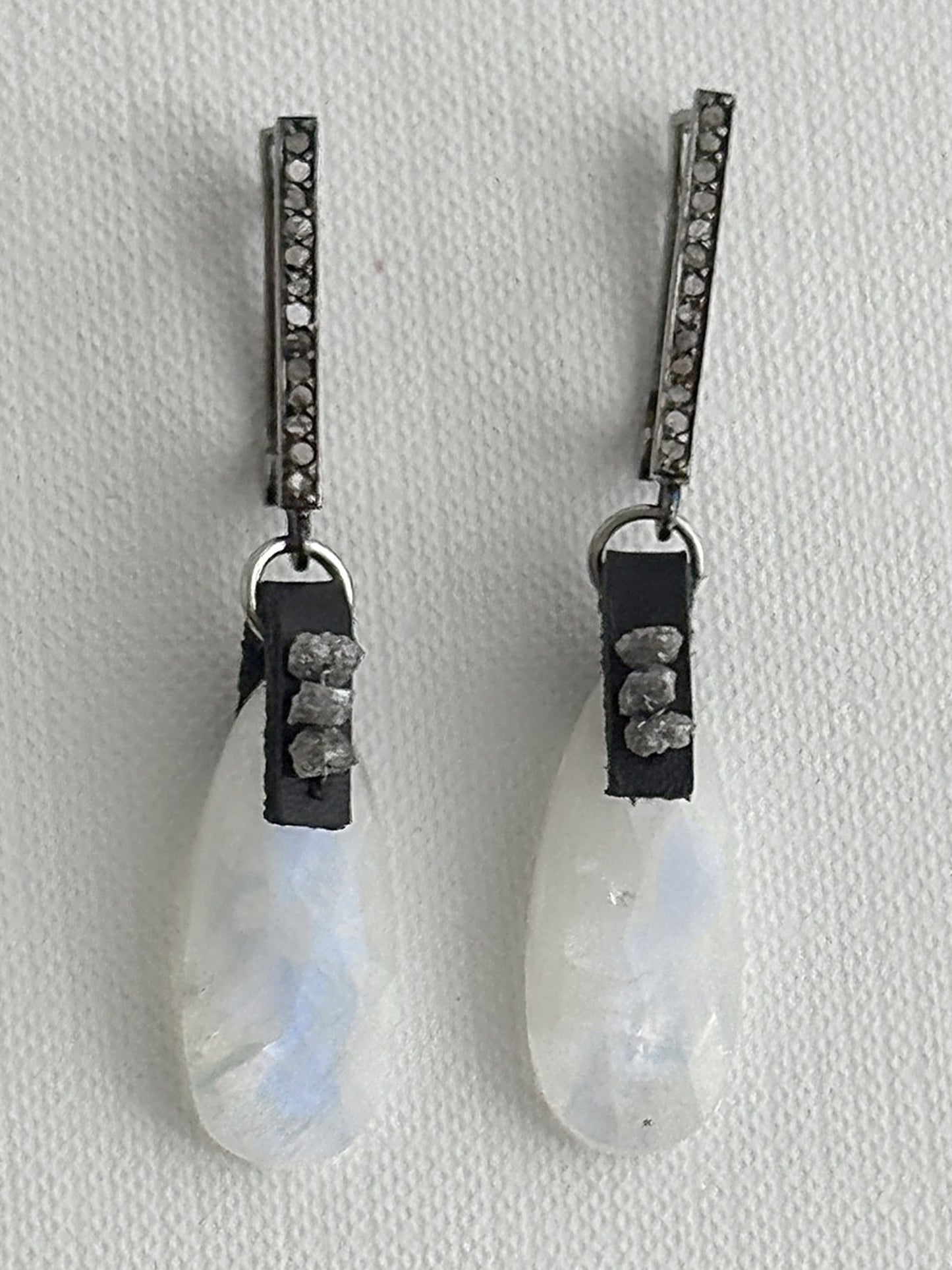Rainbow moonstone teardrop earrings with raw grey diamonds on black leather and oxidized sterling silver pavé leverbacks