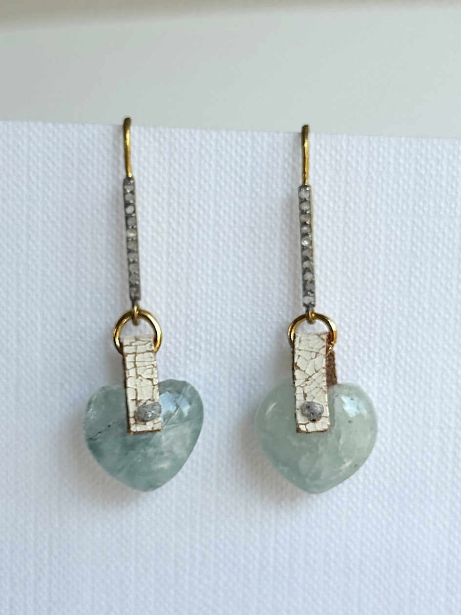 Polished aquamarine puffed heart dangle earrings with a hand-sewn raw grey diamond on ivory crackle leather and two-tone pavé diamond hooks