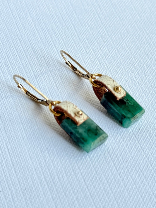Vivid green faceted emerald dangle earrings with hand-sewn 14K gold-filled beads on ivory crackle leather and 14K gold-filled leverbacks, angled view