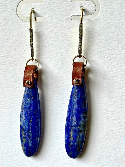 Lapis lazuli teardrop earrings hanging on a card, deep blue stones, brown leather loops