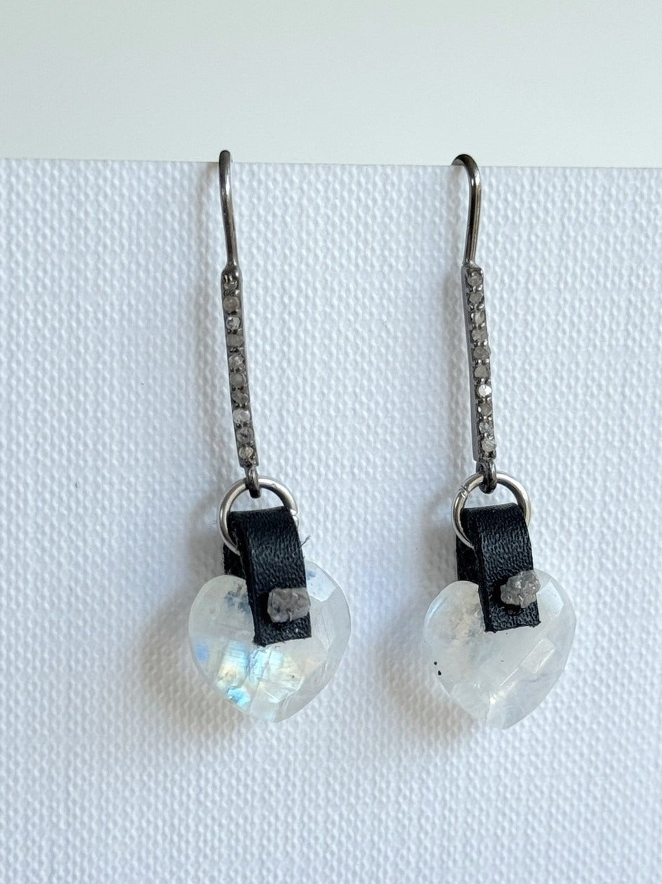 Faceted rainbow moonstone heart dangle earrings with hand-sewn raw grey diamonds on black leather and long oxidized sterling pavé diamond hooks, blue flash showing