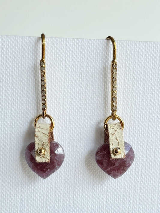 Faceted pink-red ruby heart dangle earrings with a hand-sewn 14K gold-filled bead on ivory crackle leather and long gold vermeil pavé diamond hooks, front view