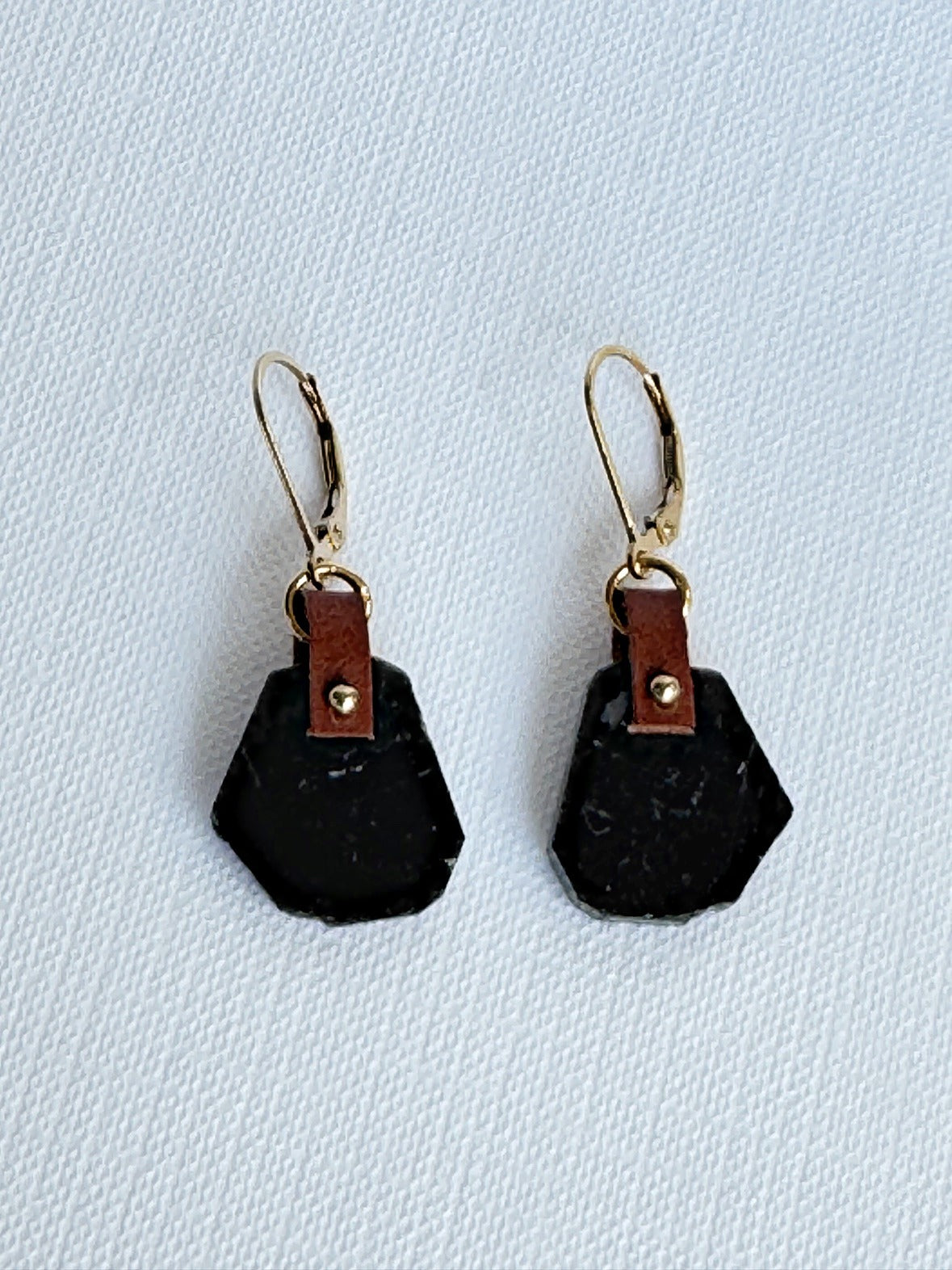 Glossy black tourmaline freeform slice earrings with hand-sewn 14K gold-filled beads on brown leather and 14K gold-filled leverbacks, front view
